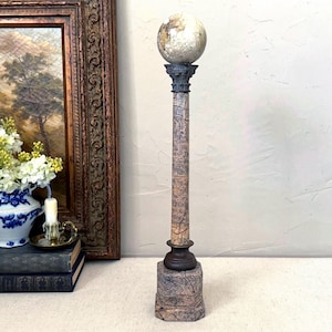 May include: A white ceramic mug with a black handle and the text "But First, Coffee" in a handwritten style. The mug is on a white surface. The mug is approximately 4 inches tall.