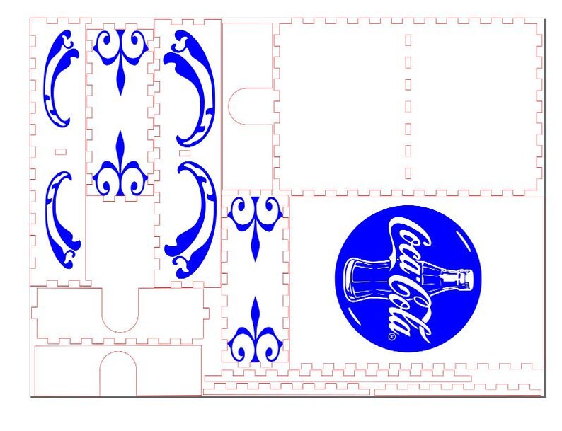 May include: A white and blue laser cut design for a Coca-Cola themed box. The design includes a Coca-Cola logo with a bottle, and several decorative flourishes.