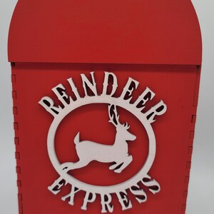 May include: Red wooden mailbox with a white reindeer and the words "Reindeer Express" on the front.