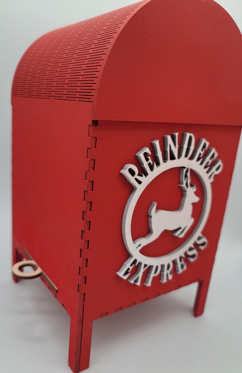 May include: Red wooden box with a white reindeer and the words "Reindeer Express" on the side. The box has a small wooden handle on the front.