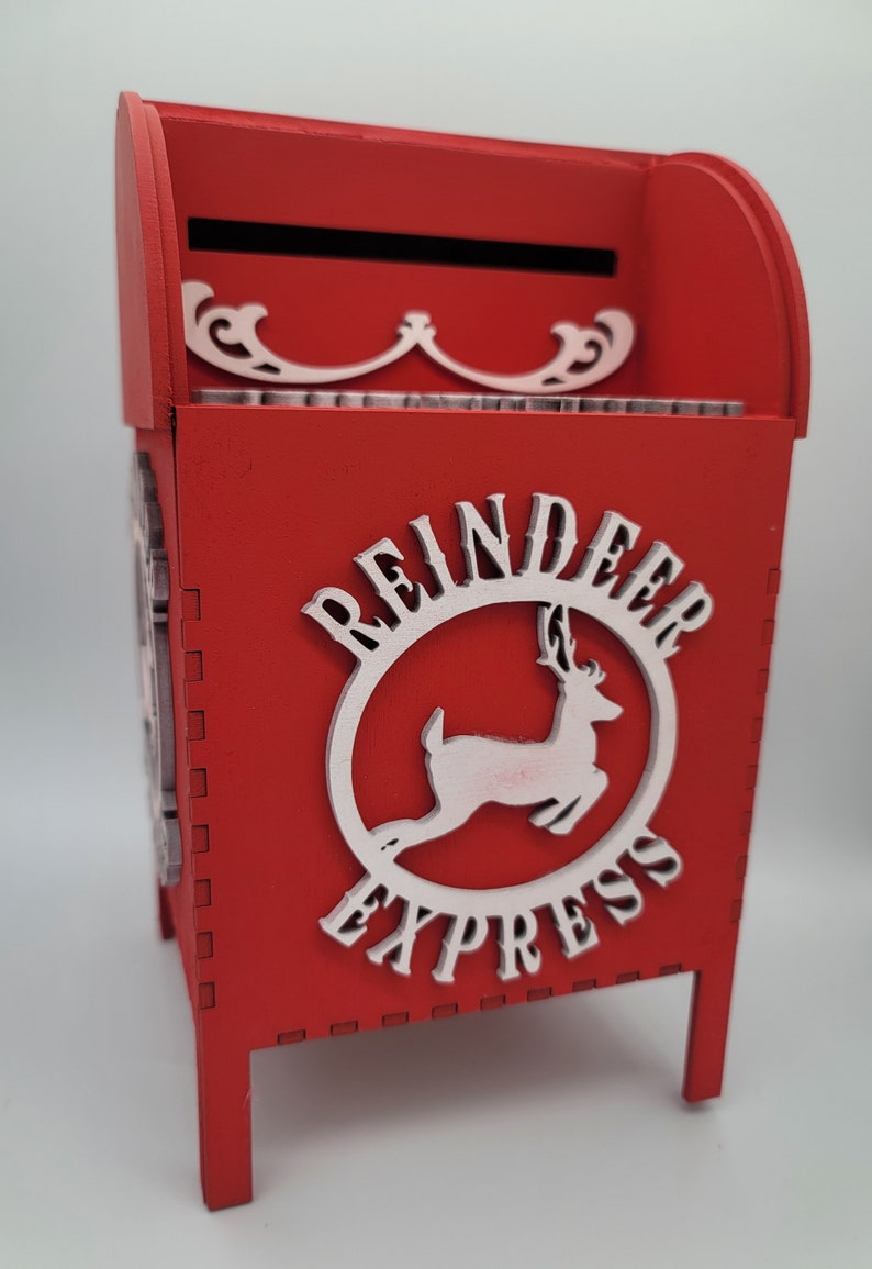 May include: Red wooden mailbox with a white reindeer and "Reindeer Express" written on it.