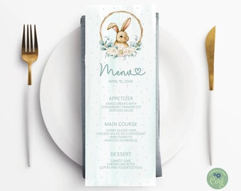 Op de afbeelding: Een lichtblauwe en groene menukaart met een aquarel-illustratie van een konijn in een krans. De menukaart heeft een titel die "Menu" zegt met een hartje en de datum "April 10, 20XX". Het menu vermeldt voorgerechten, hoofdgerechten en desserts.