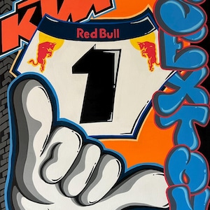 May include: A black and white number "1" with a white background and a red bull logo on either side. The number is surrounded by a black and white hand gesture, and the words "Red Bull" and "KTM" are visible in the background. The word "SEATON" is written in blue and white bubble letters on the right side of the image.