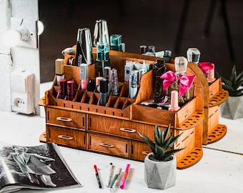 May include: A wooden organizer with multiple drawers and compartments for storing cosmetics and beauty products. The organizer is made of light brown wood and has a natural finish. It features a variety of compartments, including small drawers, shelves, and slots for bottles and tubes. The organizer is filled with various cosmetics, including lipsticks, nail polish, and perfume bottles.
