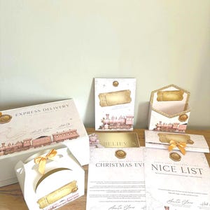 May include: A collection of Christmas-themed stationery including a large box labeled Express Delivery, a small gift box with a gold ribbon, envelopes, and documents titled Christmas Eve and Nice List, all featuring a vintage train illustration.
