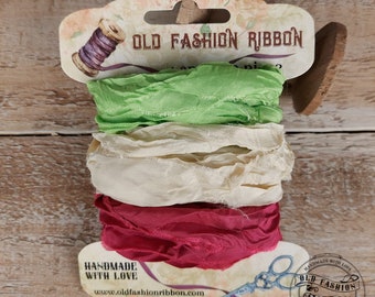 Könnte beinhalten: Eine Rolle mit drei Farben alten, modischen Bandes. Das Band ist grün, cremefarben und rot. Das Band ist handgefertigt mit Liebe und wird auf einer Karte mit dem Text "Old Fashion Ribbon" und "Handmade with Love" verpackt.