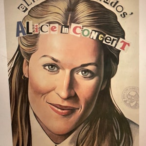 May include: A poster with a woman's face in the center. The text "Elizabeth Swados, Alice in Concert" is written across the top of the poster in magazine cutouts.
