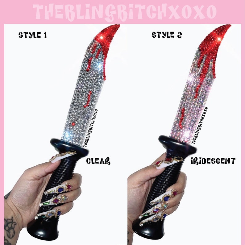 May include: Two decorative knives with a black handle and a clear and iridescent jeweled blade. The blade is shaped like a dagger and has red dripping paint. The text "THEBLINGBITCHXOXO" is on the blade. The text "STYLE 1" and "CLEAR" are on the left side of the image. The text "STYLE 2" and "IRIDESCENT" are on the right side of the image.