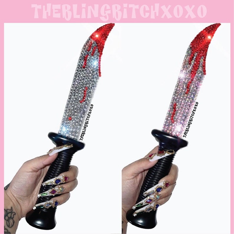 May include: A black plastic knife with a red and white rhinestone design. The knife has a fake blood drip effect and the text "THEBLINGBITCHXOXO" is printed on the blade.