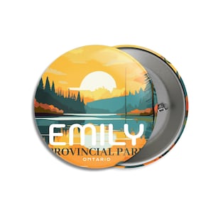 May include: A round button with a scenic landscape design. The button features a sunset over a lake with the text "EMILY PROVINCIAL PARK ONTARIO" in white. The button is approximately 2 inches in diameter.
