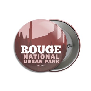 May include: Two circular badges with a red-brown design. The badges display the text "ROUGE NATIONAL URBAN PARK ONTARIO" in white. The background shows a silhouette of trees and buildings.