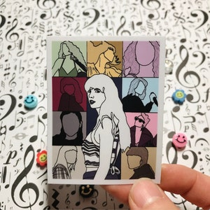 May include: A sticker with a collage of nine different portraits of a person with various hairstyles and clothing. The portraits are arranged in a 3x3 grid. The person in the center portrait has long, straight, white hair and is wearing a striped shirt. The other portraits feature different hairstyles, including short hair, long hair, and curly hair. The portraits are all in black and white.