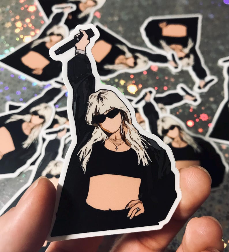 May include: A sticker featuring a black and white illustration of a person with blonde hair wearing sunglasses and a black crop top, holding a microphone.