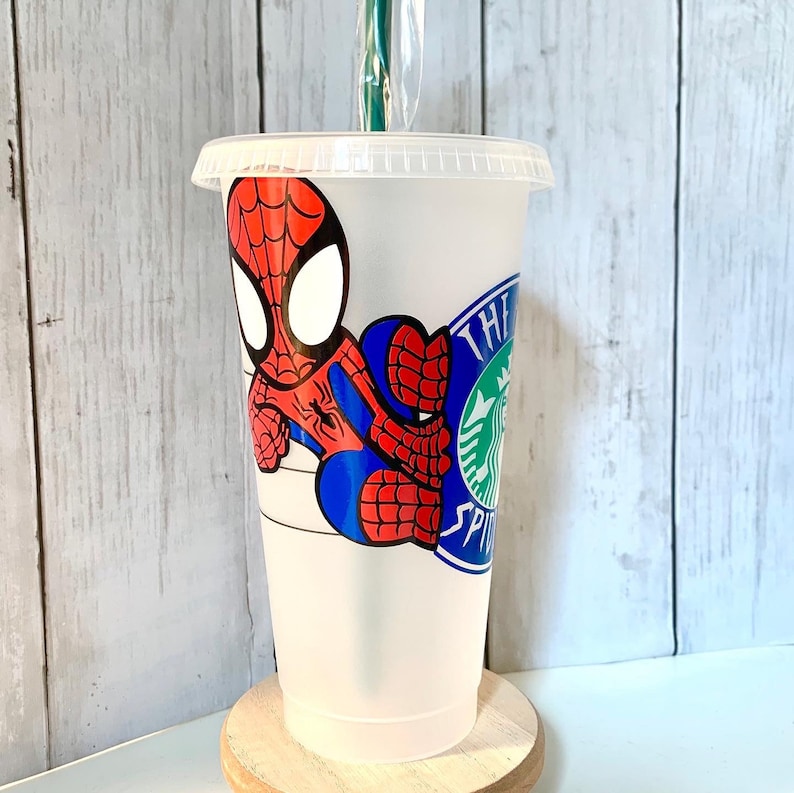 May include: A clear plastic reusable cup with a red and blue Spiderman design and the text "The Starbucks Siren" on the side.