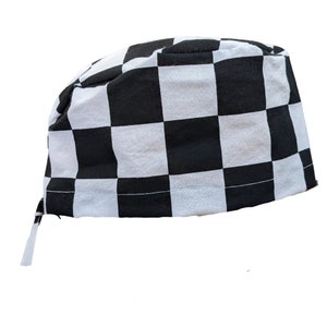May include: A black and white checkered chef's hat, a classic design. The hat is made of fabric and features a tie at the back for an adjustable fit. The checkered pattern is composed of evenly sized black and white squares.