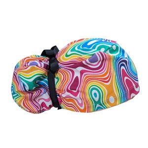 May include: A colorful surgical cap with a rainbow swirl pattern and a black tie. The cap is made of a soft, comfortable fabric and is designed to be worn during surgery or other medical procedures.