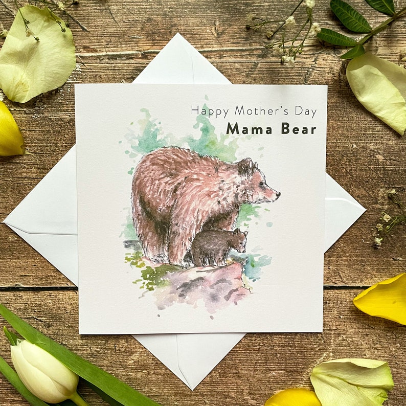May include: A watercolor illustration of a brown bear and a cub on a rock. The text "Happy Mother's Day Mama Bear" is printed on the card.