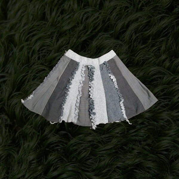 Upcycle skirt remade from second hand grey woollen jersey skirt and grey suit textile waste pieces decorated with frills