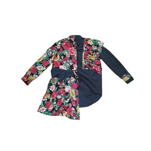 Upcycled refashioned shirt remade from repurposed reused black and floral printed second hand blouses with asymmetric bottom and frills.