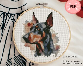 May include: A cross-stitch pattern of a Doberman Pinscher dog with a watercolor background. The pattern is on a 14 count Aida cloth, measuring 8.29 inches by 9.64 inches.