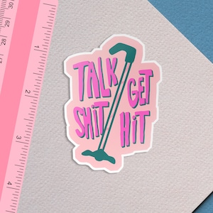 May include: Pink and green sticker with the text "Talk Shit Get Hit" and a green golf club.