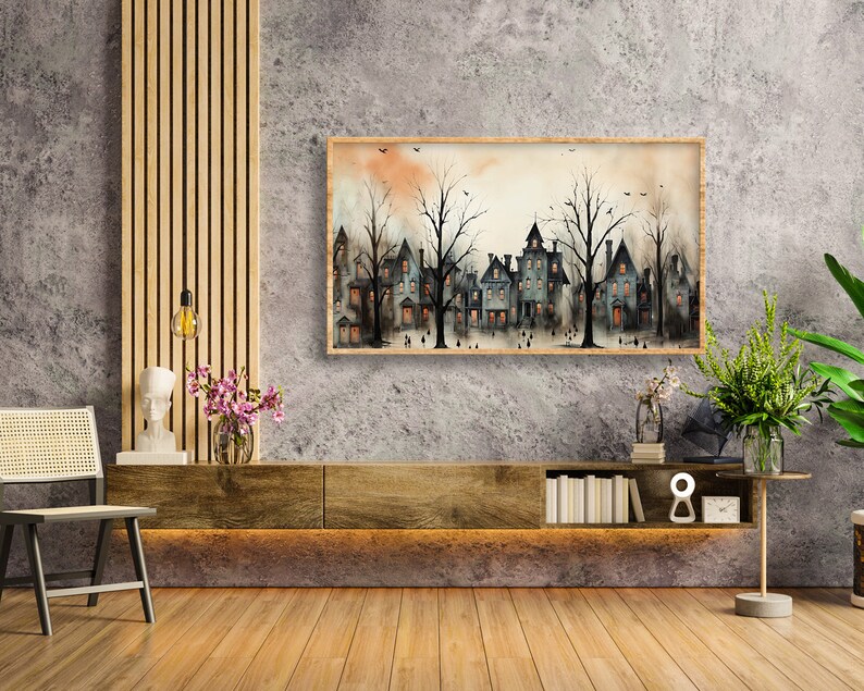 May include: A watercolour painting of a row of houses with trees in front of them. The houses are painted in shades of grey and blue, and the trees are painted in shades of green. The painting is framed in a wooden frame and is hanging on a grey wall.