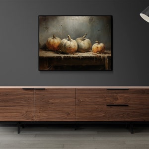 May include: A painting of four gourds on a wooden table. The gourds are a light brown color with a white, textured surface. The background is a light gray with a textured surface.