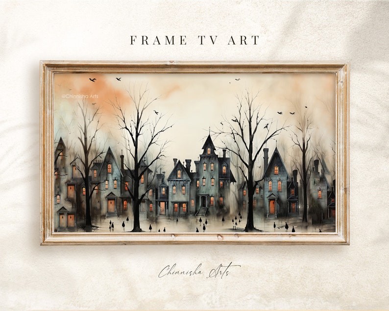 May include: A framed watercolour painting depicting a row of houses with illuminated windows at dusk. The houses are surrounded by bare trees and there are small figures walking in front of them. The sky is a soft orange and yellow.