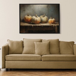 May include: A painting of four gourds on a wooden table. The gourds are various shades of white and orange. The background is a muted blue.