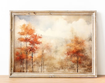 May include: A framed watercolor painting of a forest scene with trees in shades of orange, brown, and yellow. The background is a hazy blue and white, suggesting a cloudy sky.