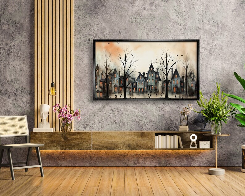 May include: A watercolour painting depicting a row of houses with trees in front of them. The houses are painted in shades of grey and blue, and the trees are painted in shades of green and brown. The painting is framed in black and is hanging on a grey wall.