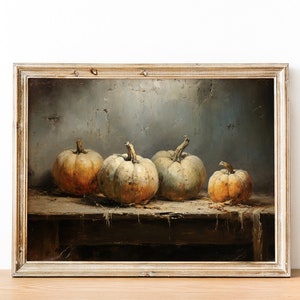 May include: A framed oil painting depicting a still life of four gourds on a wooden table. The gourds are various shades of beige and brown, and the table is weathered and worn. The background is a muted blue-gray.