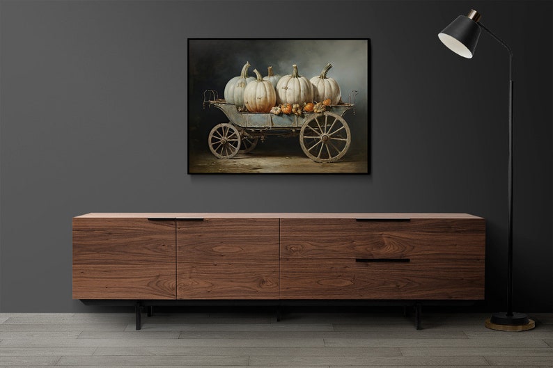May include: A painting of a vintage wagon filled with white pumpkins and smaller orange pumpkins. The wagon is on a dirt road with a dark background.