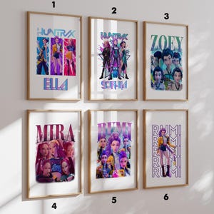 May include: Six framed art prints with colorful illustrations. The prints feature stylized images of characters with names like Ella, Sophia, Zoey, Mira, and Rumi. The word "HUNTRAX" is displayed on two prints.