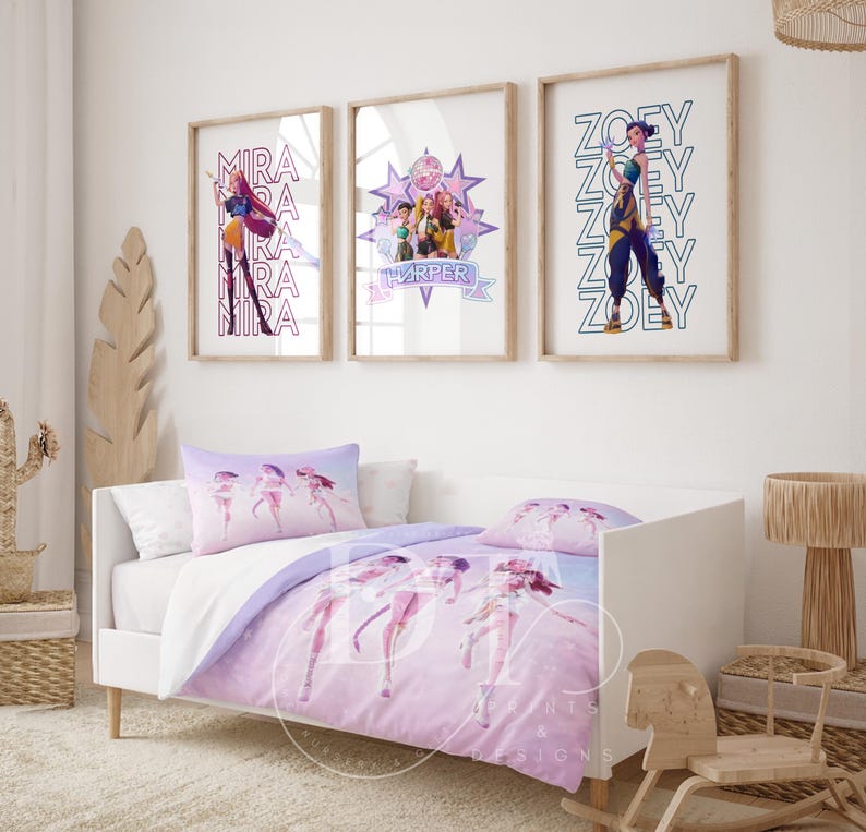 May include: A child's bedroom set featuring a white bed with a lavender and white comforter and pillow set. Above the bed are three framed prints with character illustrations and names. The room is decorated with a wooden cactus and a woven basket.