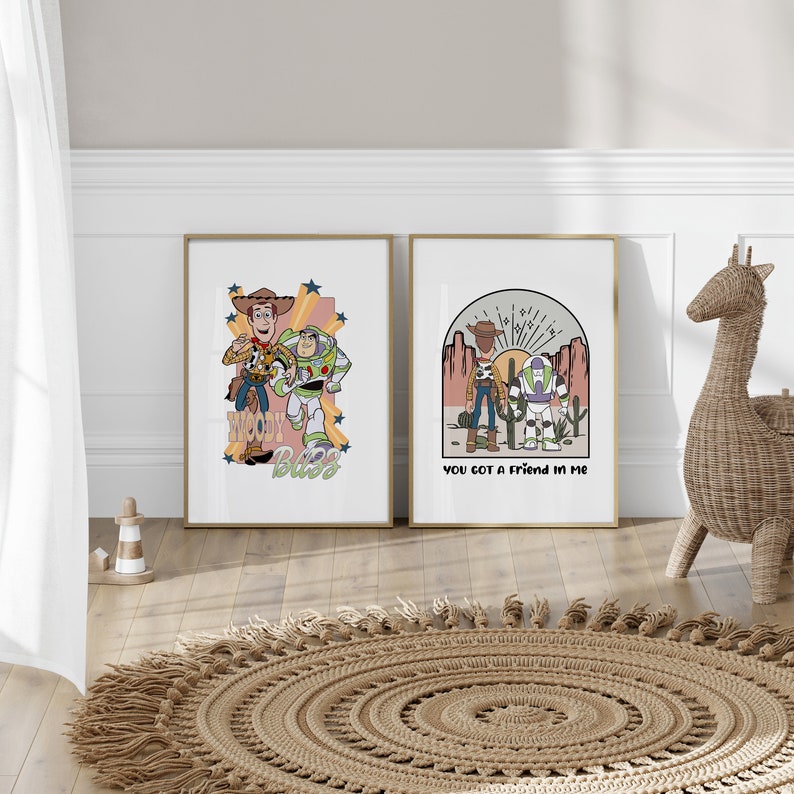 May include: Two framed prints with a Toy Story theme. The first print features Woody and Buzz Lightyear with the text "Woody Buzz". The second print features Woody and Buzz Lightyear with the text "You got a friend in me".