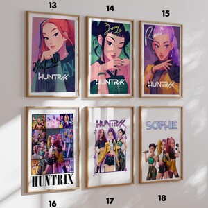 May include: Six framed art prints featuring illustrations of women with the text "HUNTRAX" and individual names. The prints have a variety of colors, including red, green, purple, and yellow. The prints are in wooden frames.