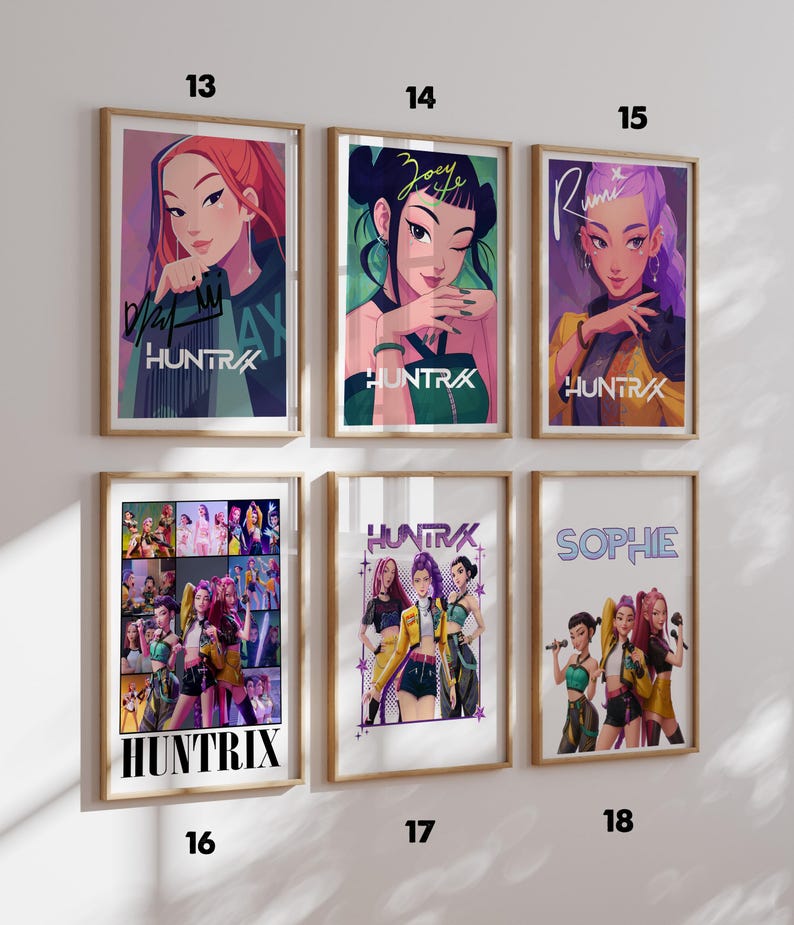 May include: Six framed art prints featuring illustrations of women with the text "HUNTRAX" and individual names. The prints have a variety of colors, including red, green, purple, and yellow. The prints are in wooden frames.