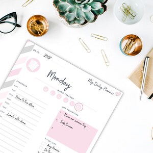 May include: A pink and gray printable daily planner with the text "My Daily Planner" and "Monday" on the top. The planner includes sections for schedule, mood tracker, top priorities, and a to-do list.
