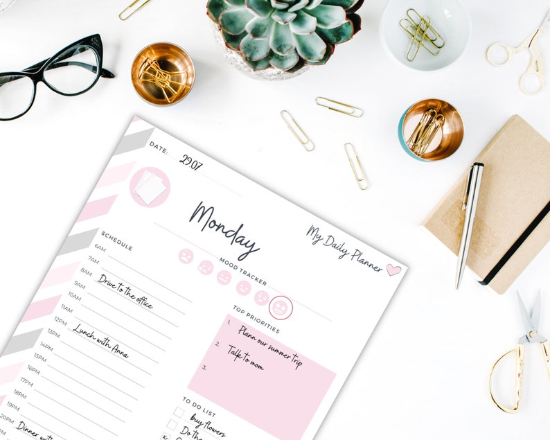 May include: A pink and gray printable daily planner with the text "My Daily Planner" and "Monday" on the top. The planner includes sections for schedule, mood tracker, top priorities, and a to-do list.