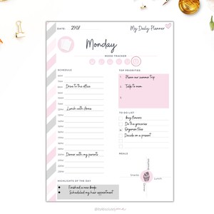 May include: A printable daily planner with a pink and gray striped background. The planner includes sections for scheduling, mood tracking, top priorities, a to-do list, and meal planning. The planner is titled "My Daily Planner" and features a heart icon. The date is 29.07 and the day is Monday.