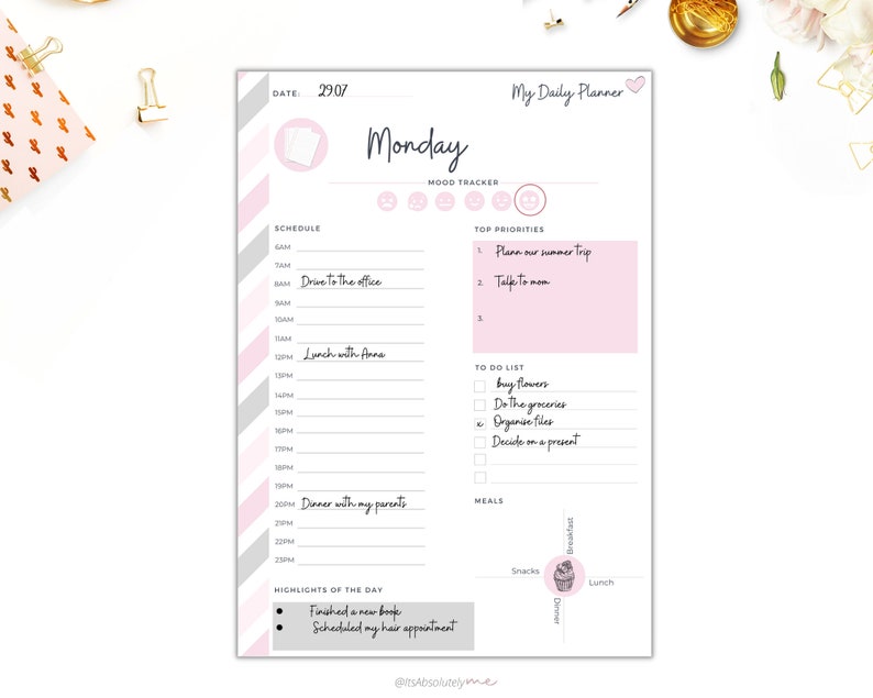 May include: A printable daily planner with a pink and gray striped background. The planner includes sections for scheduling, mood tracking, top priorities, a to-do list, and meal planning. The planner is titled "My Daily Planner" and features a heart icon. The date is 29.07 and the day is Monday.