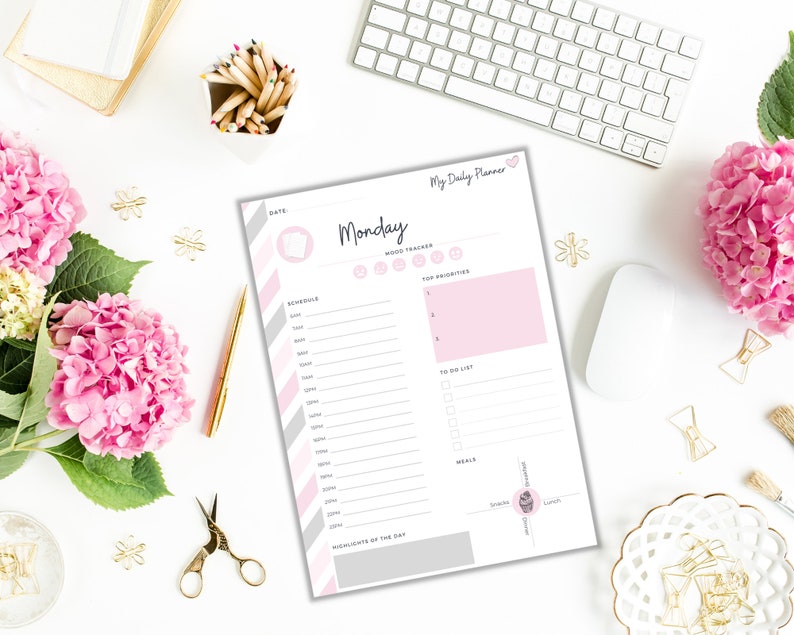 May include: A printable daily planner with a pink and gray color scheme. The planner includes sections for scheduling, mood tracking, top priorities, a to-do list, meals, and highlights of the day. The text "My Daily Planner" is at the top of the page, and the day of the week "Monday" is in a large font.