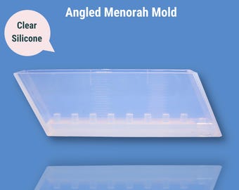 May include: Clear silicone mold for making an angled menorah. The mold has nine cavities for candles.