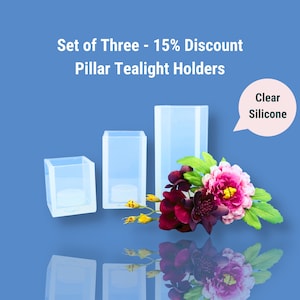 May include: Set of three clear silicone pillar tealight holders. The holders are in different sizes and are arranged in a row from smallest to largest. The holders are on a blue background with a flower arrangement in front of them. The text "Clear Silicone" is in a speech bubble above the holders.