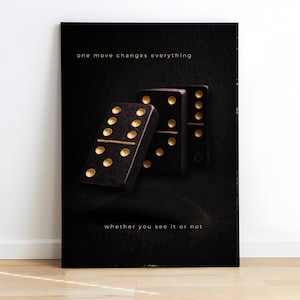 May include: A black canvas print featuring three dominoes with gold dots and lines. The text "one move changes everything" and "whether you see it or not" are displayed in a white font.