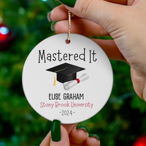 May include: White ceramic bauble with black text that reads "Mastered It" and a black graduation cap and diploma. The text below reads "Elise Graham Stony Brook University -2024- "