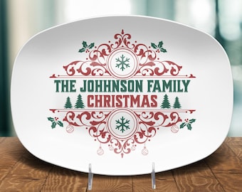 May include: White oval serving platter with a Christmas design. The platter features the text "THE JOHNSON FAMILY CHRISTMAS" in green, with red and green decorative elements including snowflakes, holly, and ornaments.