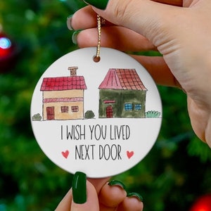 May include: White ceramic Christmas ornament with a watercolor illustration of two houses and the text "I wish you lived next door".
