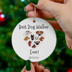 May include: White round Christmas bauble with a heart-shaped design featuring various dog breeds. The text reads "Best Dog Walker Ever! Jessica".